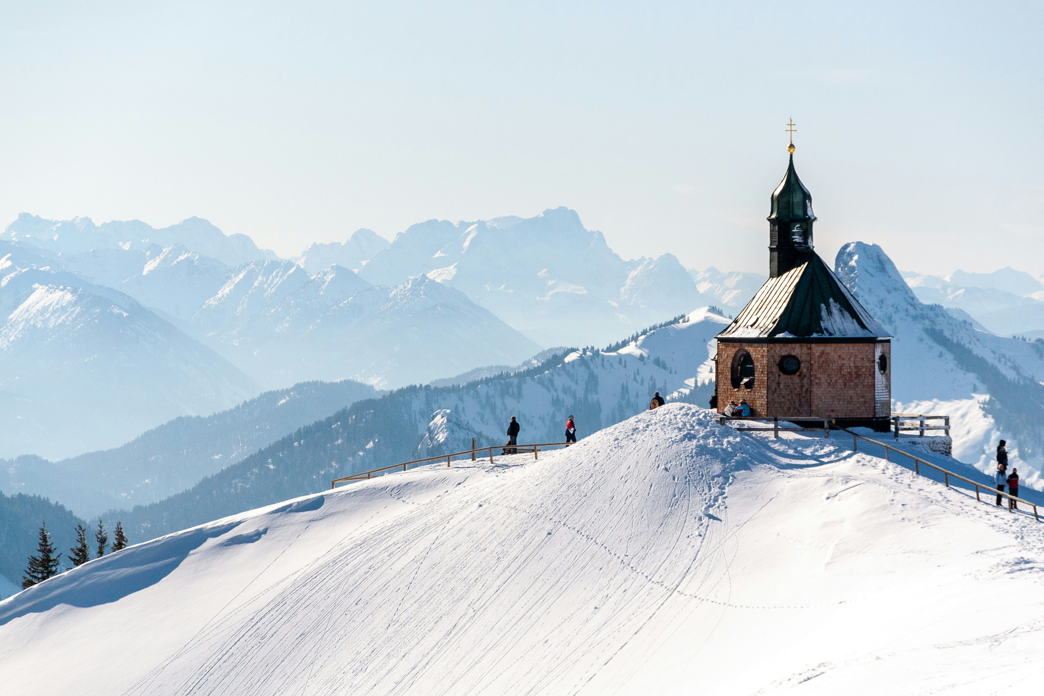 brown and white house on snow covered mountain during daytime